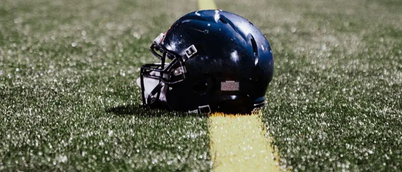 A helmet on the field after dark